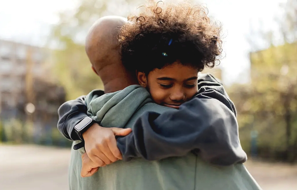 Family members embracing while supporting a loved one through recovery